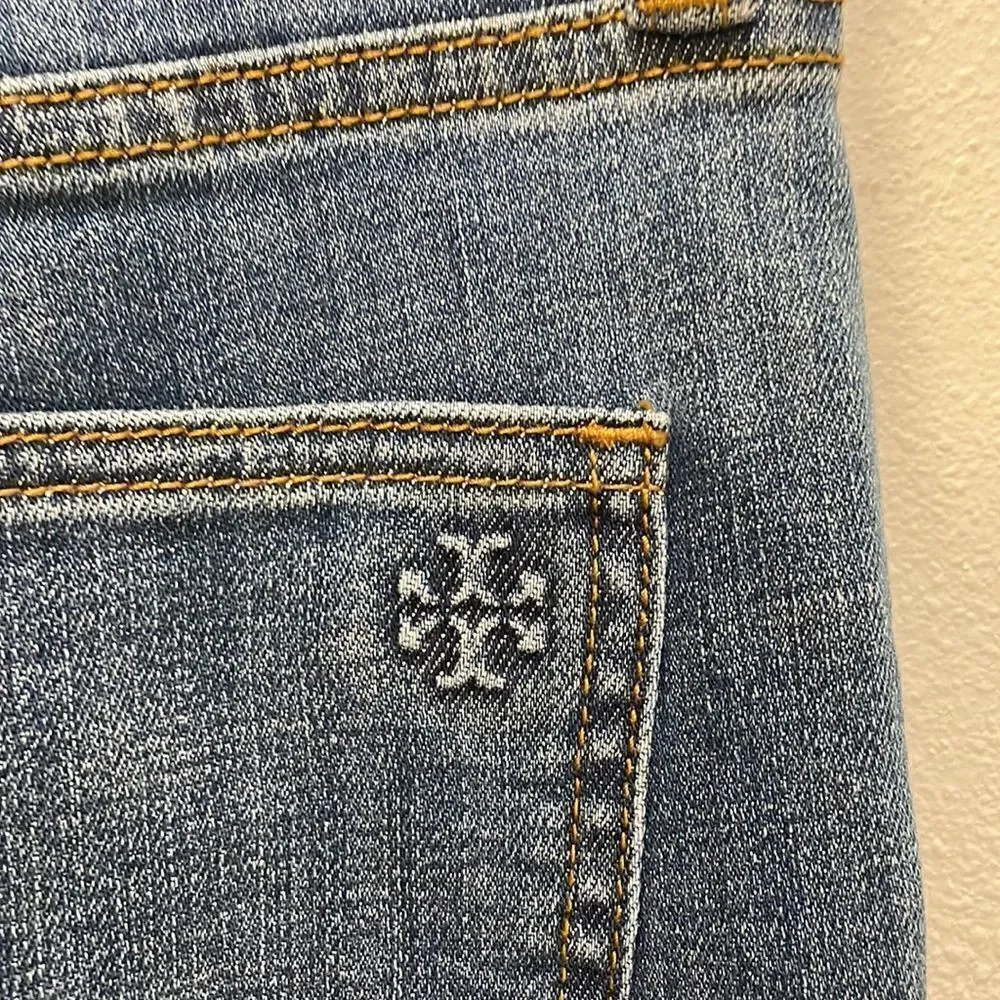 Tory Burch Connor jeans in medium allover stone wash. Cropped. Raffia fringed